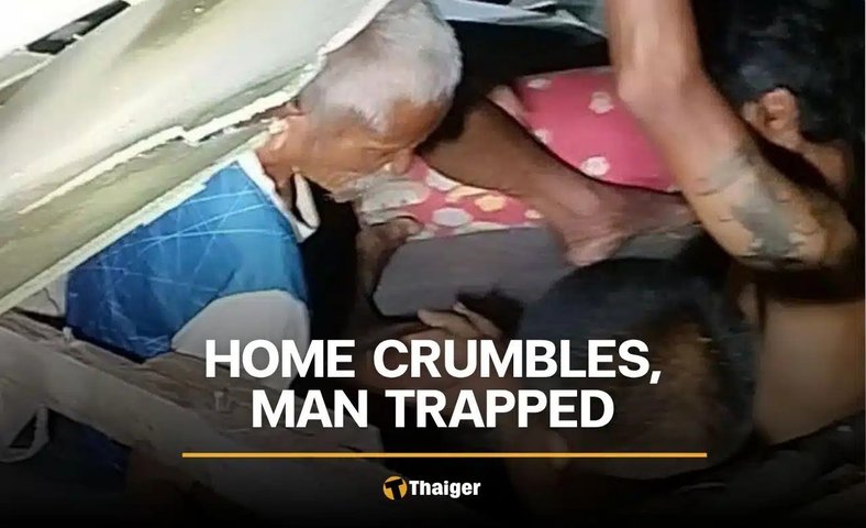 View full size Neighbours dig out a 70-year-old man after his old wooden house collapses